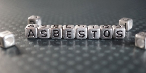 Gray blocks with black letters that spell out "asbestos"