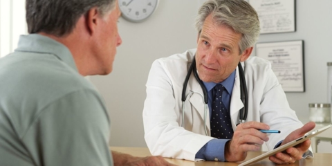 Senior man speaking to doctor.