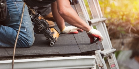 Man doing a roof shingle installation